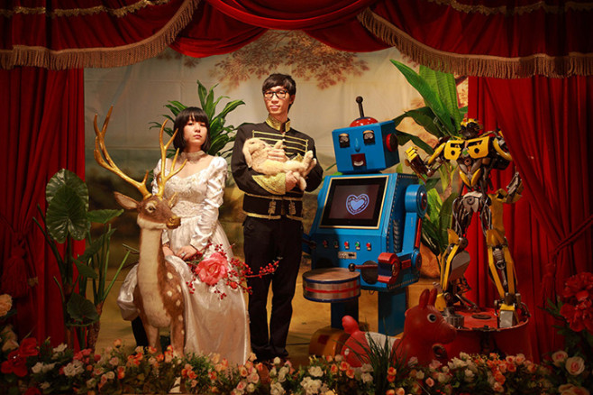 A couple posing with robots