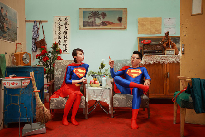 A couple wearing matching Superman outfits