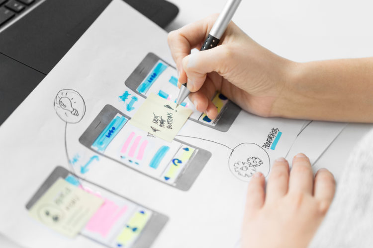 app design, technology and business concept - web designer working on user interface and creating layout at office