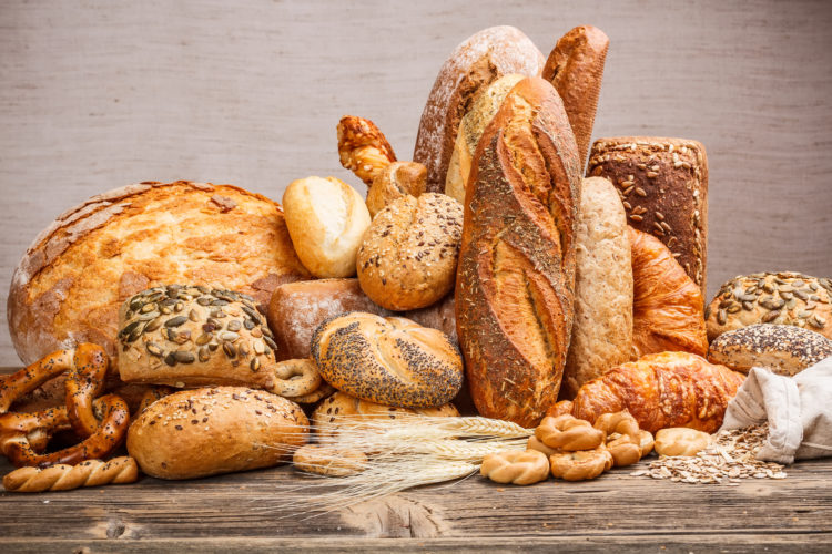 Variety of bread on old wooden table