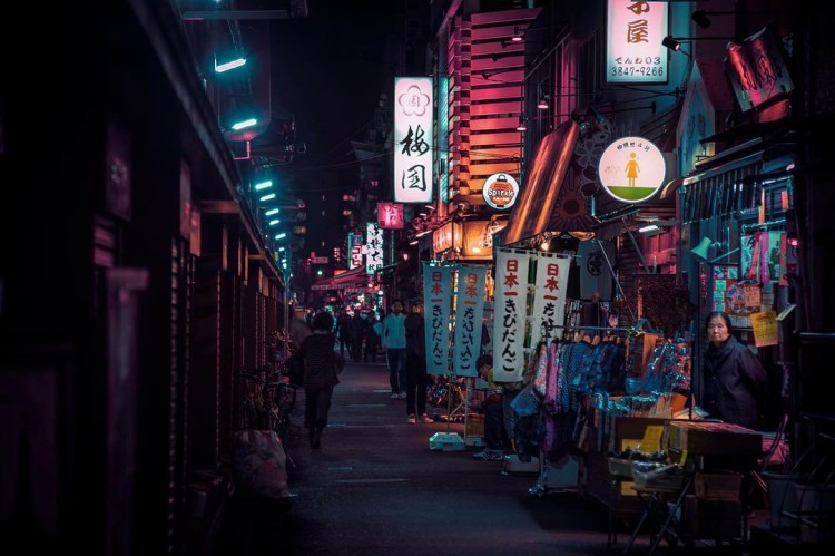 Asakusa Nights 浅草 2042 Wandering around the Asakusa backalleys, I happen upon one of the few people to notice me capturing the night. I lower my camera; despite the chill she greets me with a warm smile.