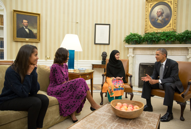 President Barack Obama, First Lady Michelle Obama, and their daughter Malia meet with Malala Yousafzai, the young Pakistani schoolgirl who was shot in the head by the Taliban a year ago, in the Oval Office, Oct. 11, 2013. (Official White House Photo by Pete Souza)