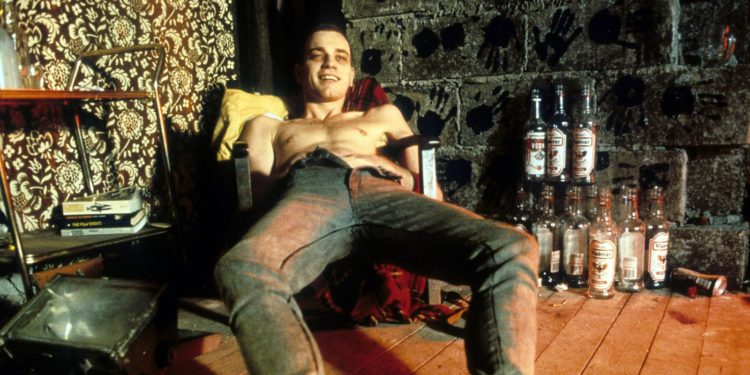 Ewan McGregor reclines in a chair in a scene from the film 'Trainspotting', 1996. (Photo by Miramax/Getty Images)