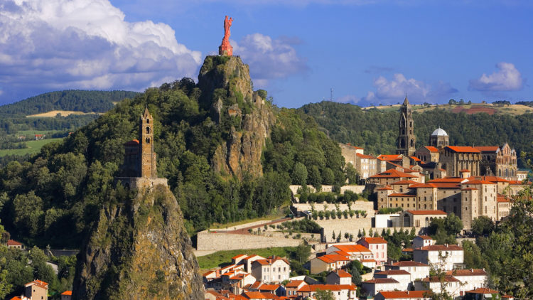 Le Puy, France – The church of St. Michel d’Aiquilhe atop the pinnacle of Rocher St. Michel, and a statue of the Virgin and Child atop the peak of Rocher Corneille overlook Le Puy, France. – Image by © Jose Fuste Raga / Corbis